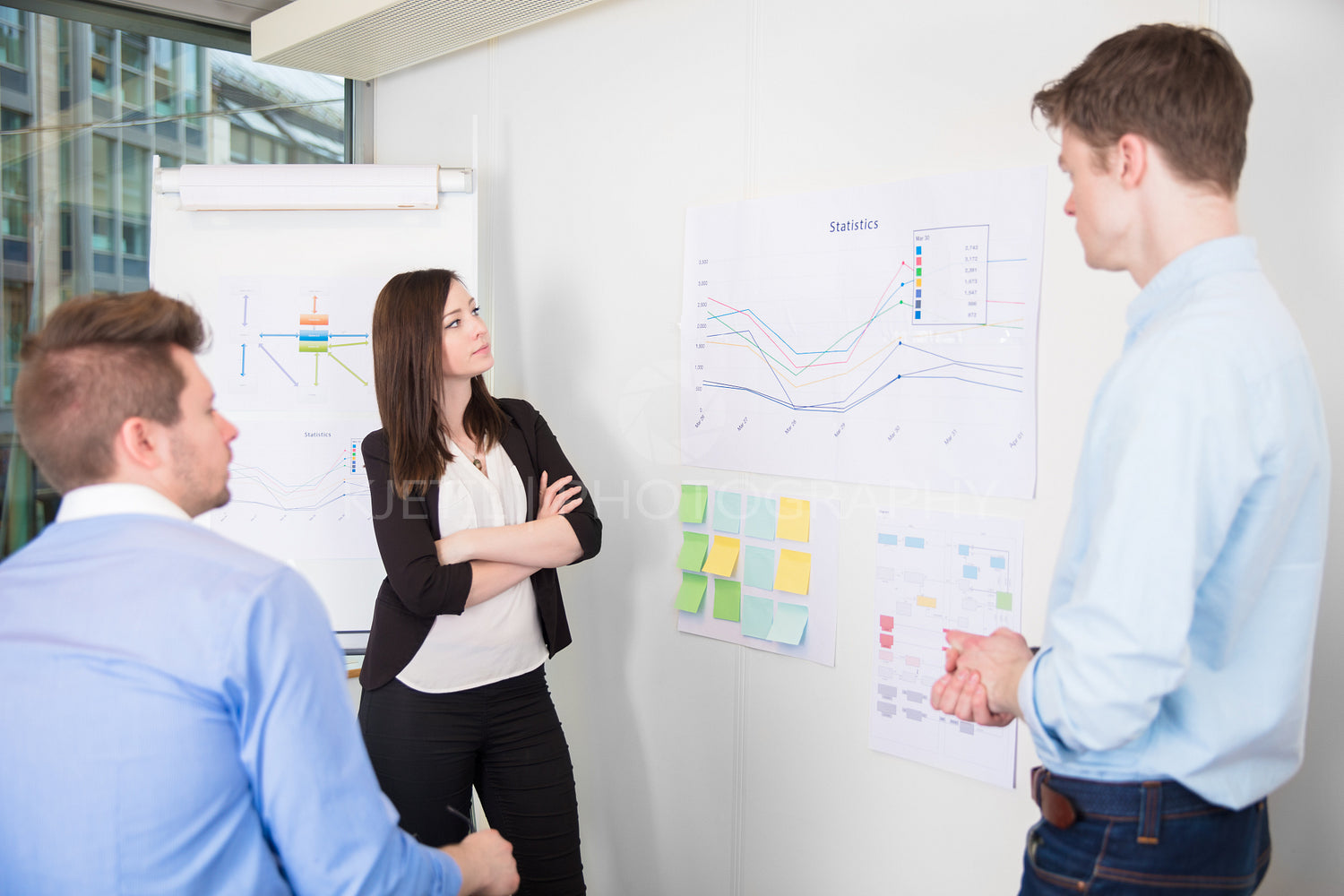 Business People Discussing Over Line Graph In Office