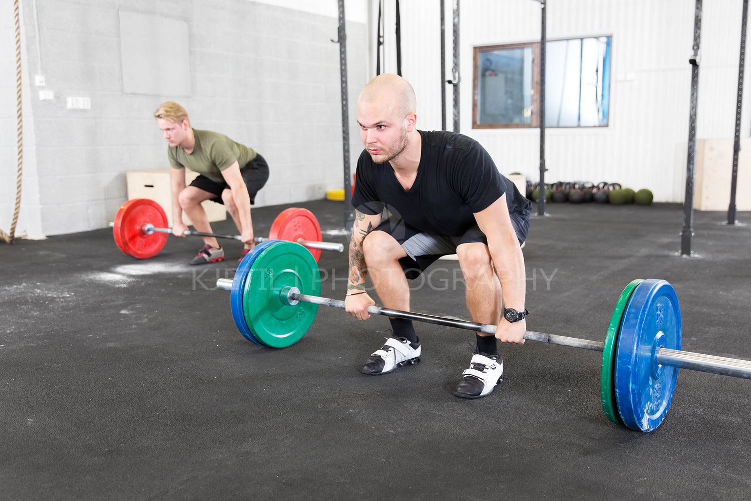 Group trains deadlift at fitness gym center