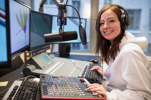 Confident Female Host Smiling In Radio Station