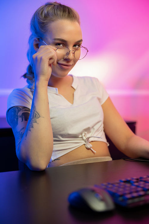 Professional gamer girl with headset play online multiplayer video game on PC