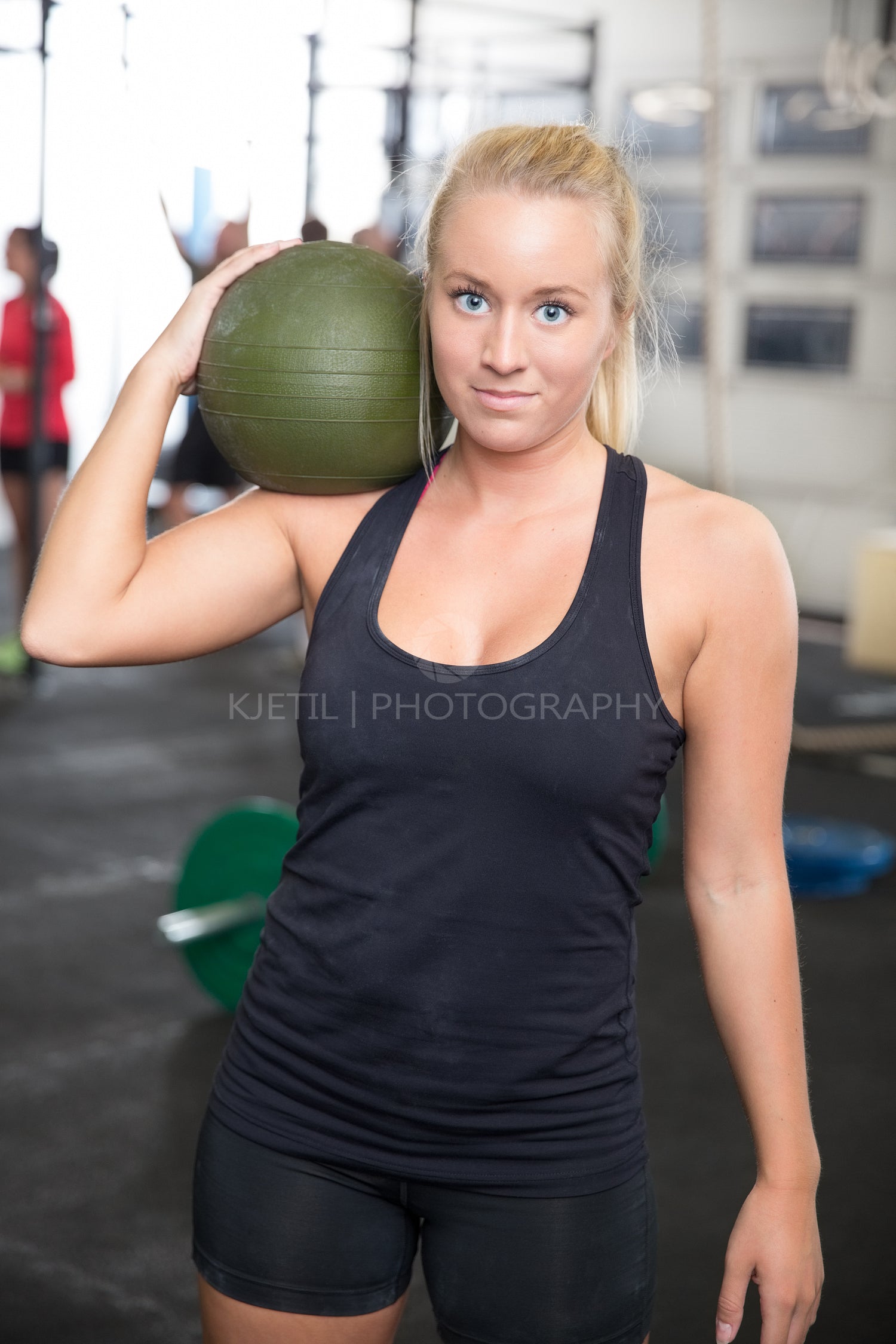Blonde fitness woman with slam ball