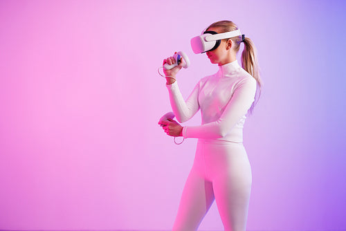 Female athlete in VR glasses practicing martial arts