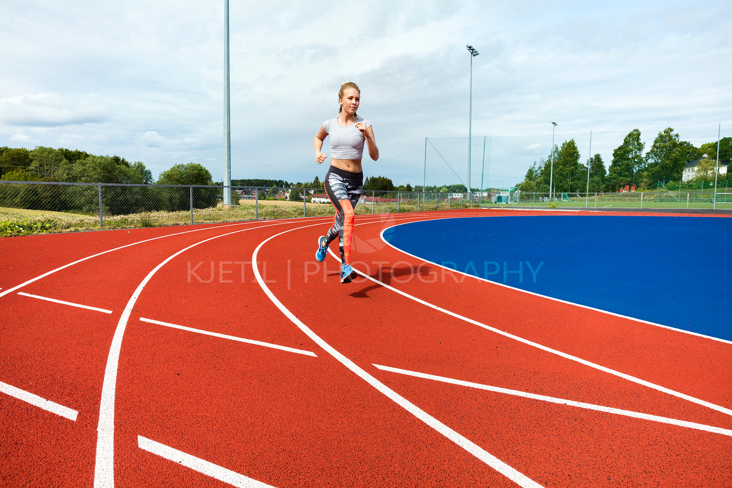Determined Woman Running On Sports Tracks