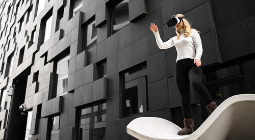 Environmental Portrait of Woman Using Virtual Reality Glasses and Shoping In Metaverse Business