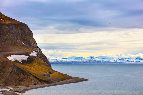 Houses and mountains in arctic summer landscape