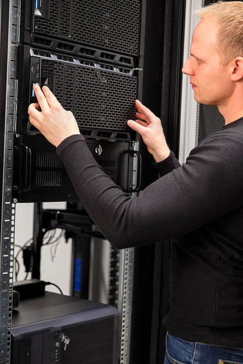 It consultant working with installation of a server in datacenter
