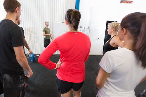 Personal trainer instructs his fitness workout team