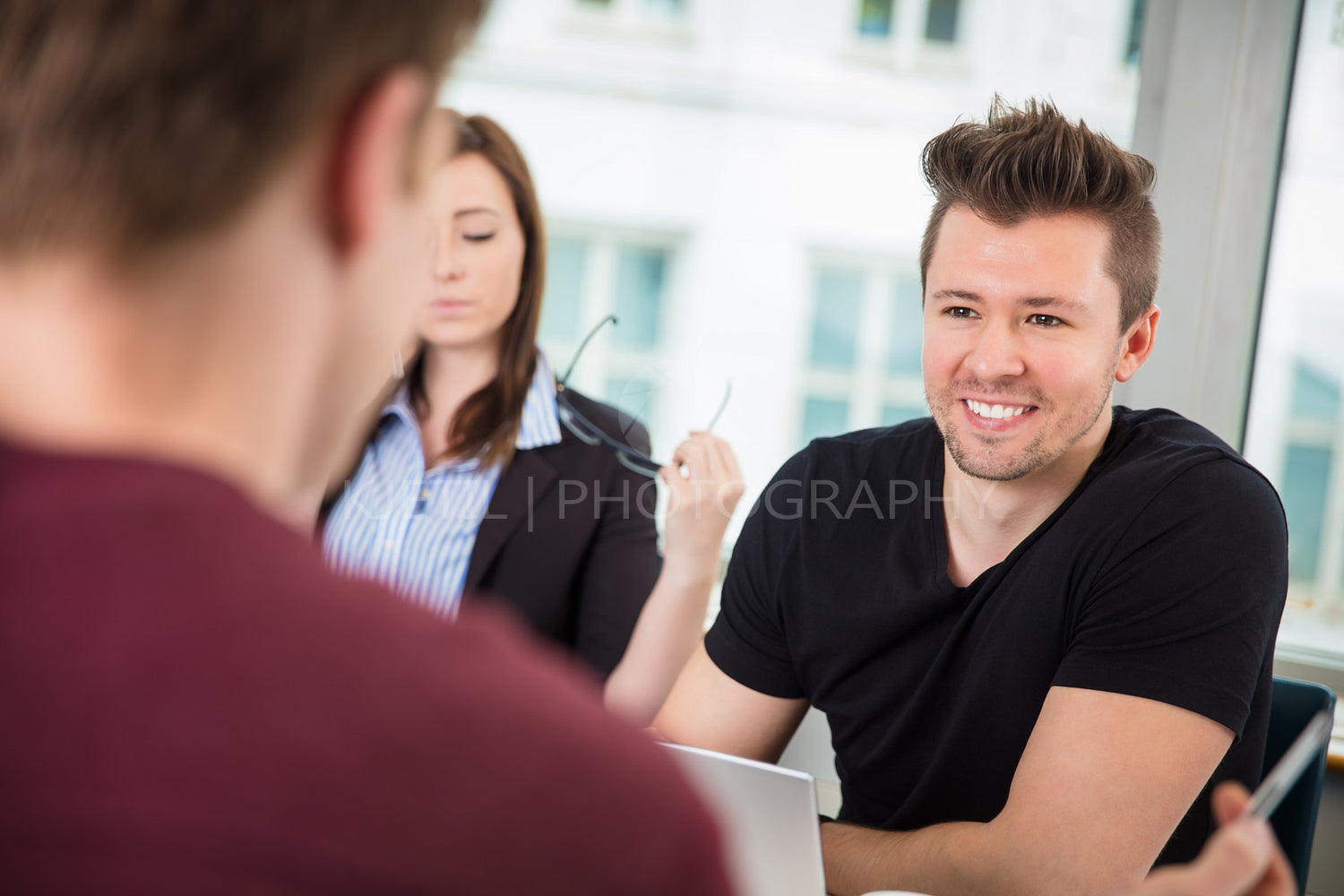 Businessman Smiling While Looking At Colleague