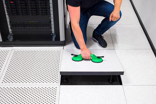 Computer Engineer Pulling Floor Tile Using Suction Cups In Datac