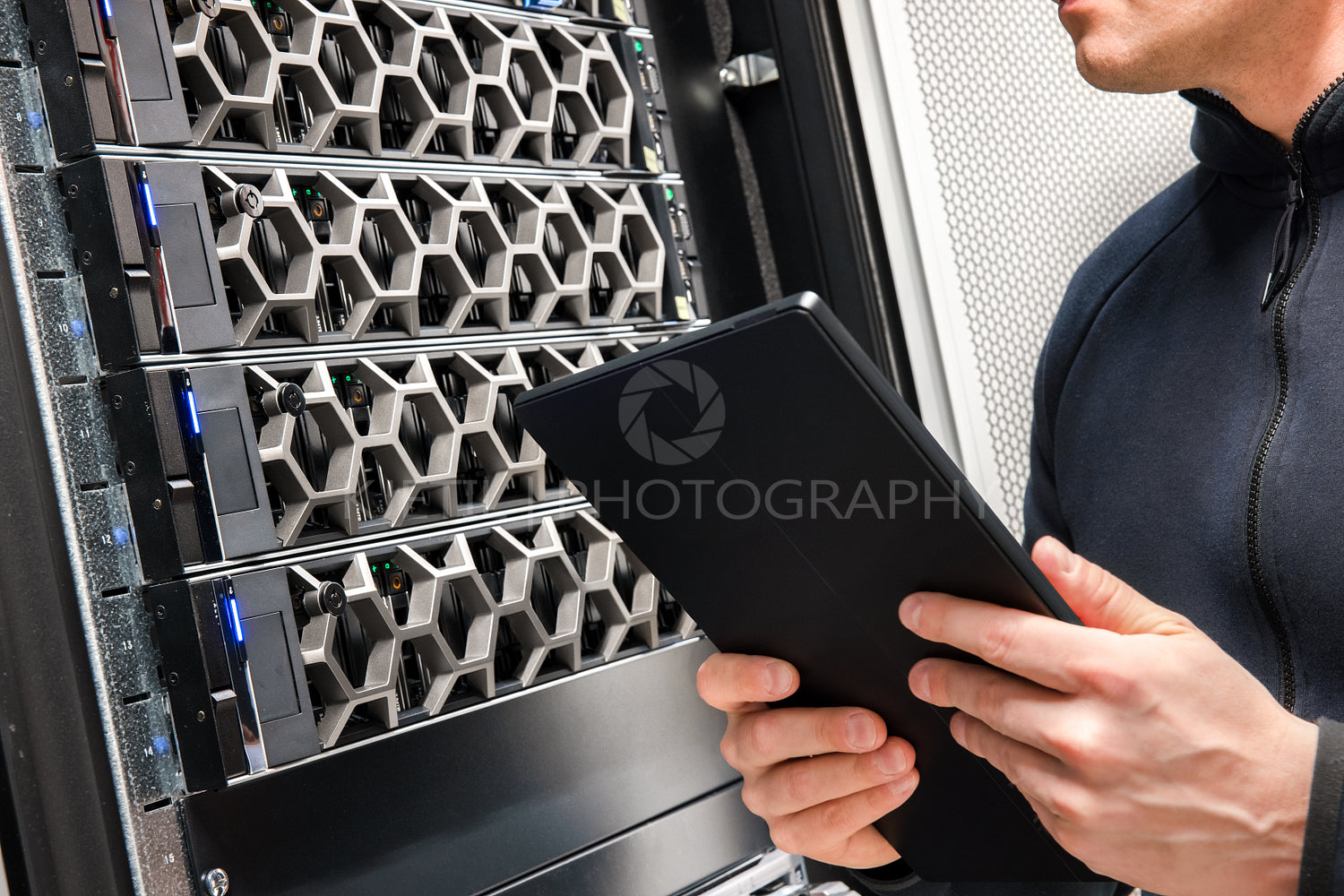 Male Technical Consultant With Digital Tablet Examining Hardware