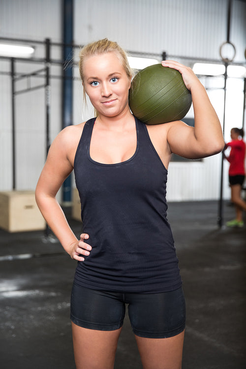 Woman with slam ball at fitness gym center