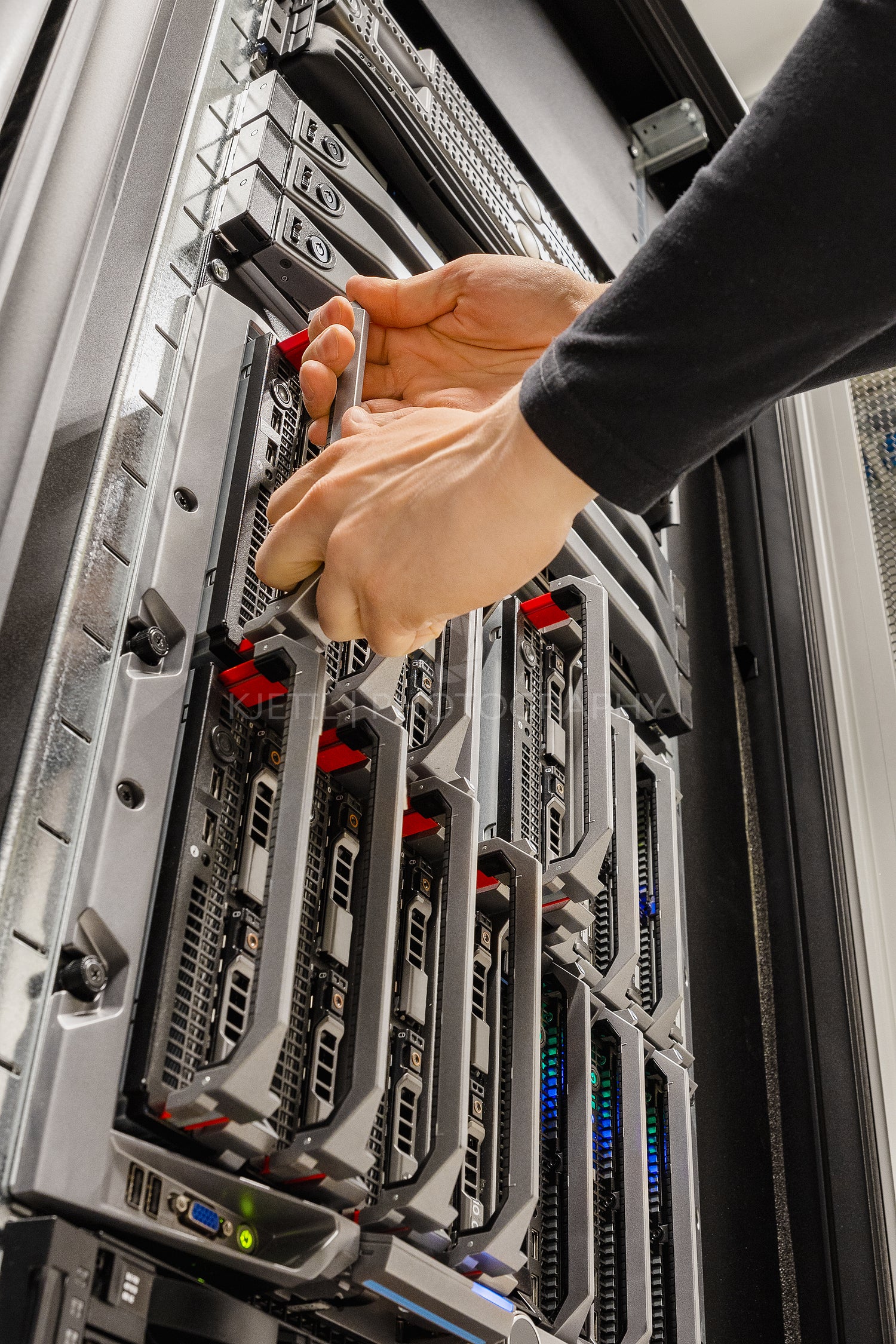 Male IT Consultant Removing Blade Server From Rack in Datacenter