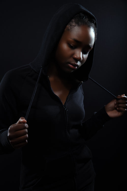 Cool and pensive woman with dark skin and attitude wearing hoodie