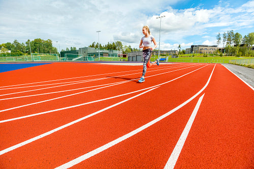 Young Woman Running On Sports Tracks