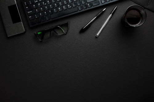 Computer Keyboard With Pens, Eyeglasses And Smartphone On Gray D