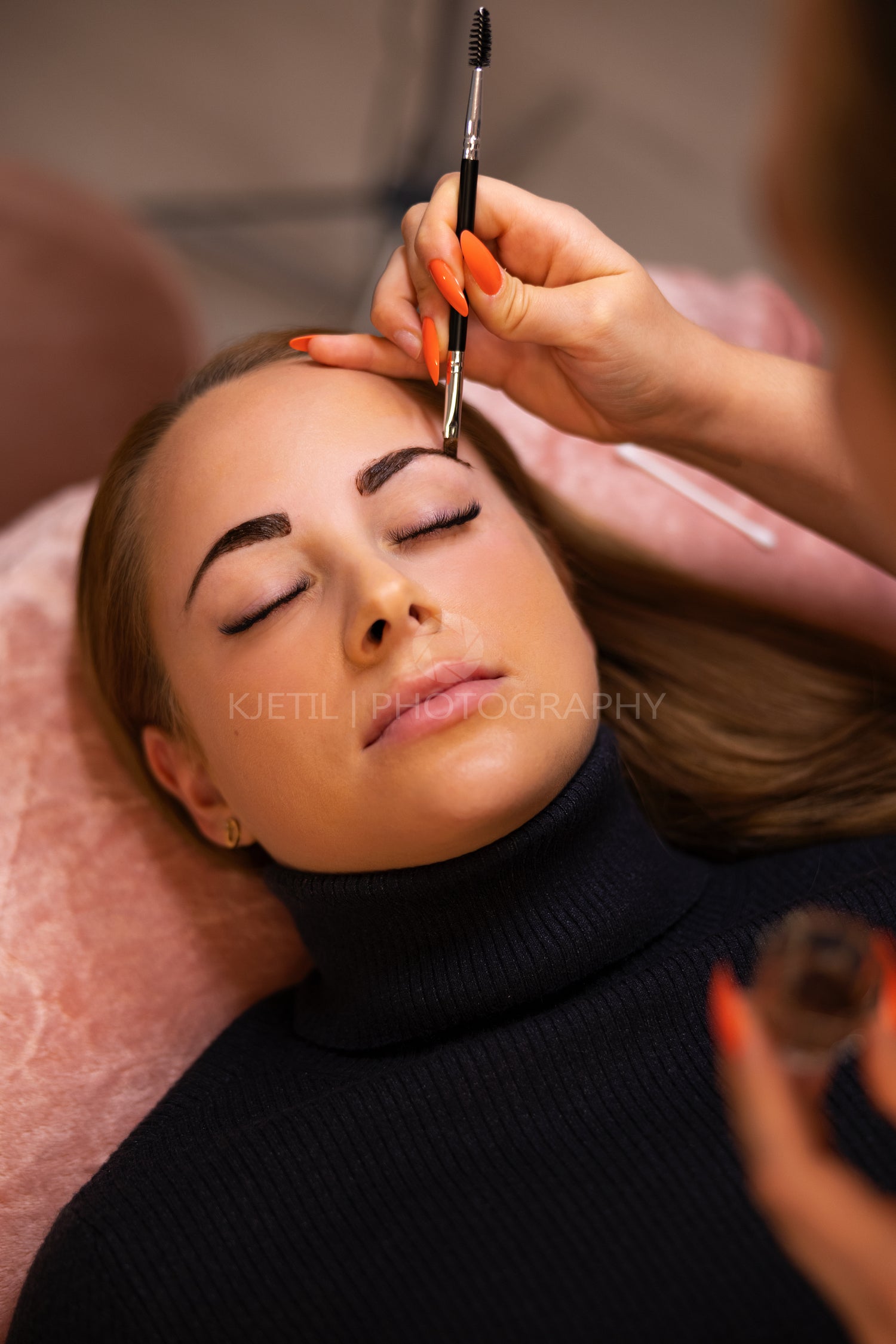Female Specialist Applying Dye On Client's Eyebrow