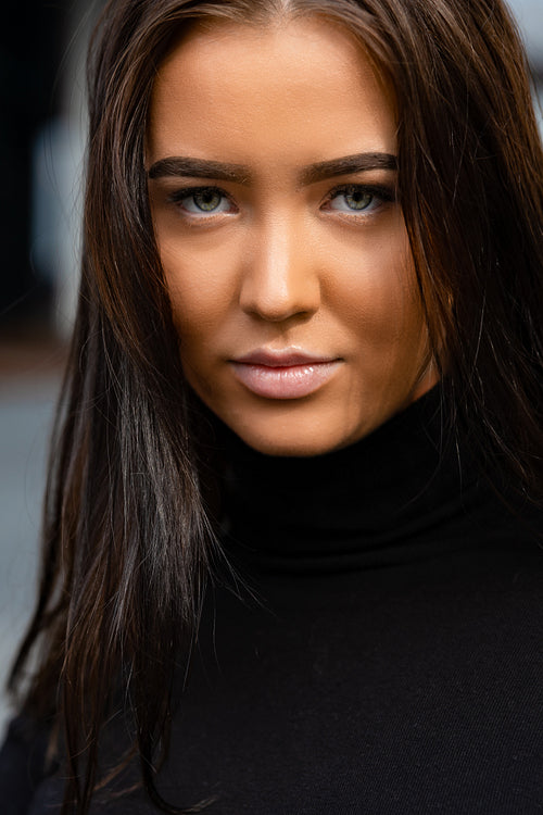 Close-up Face Portrait Of Attractive Young Woman In City