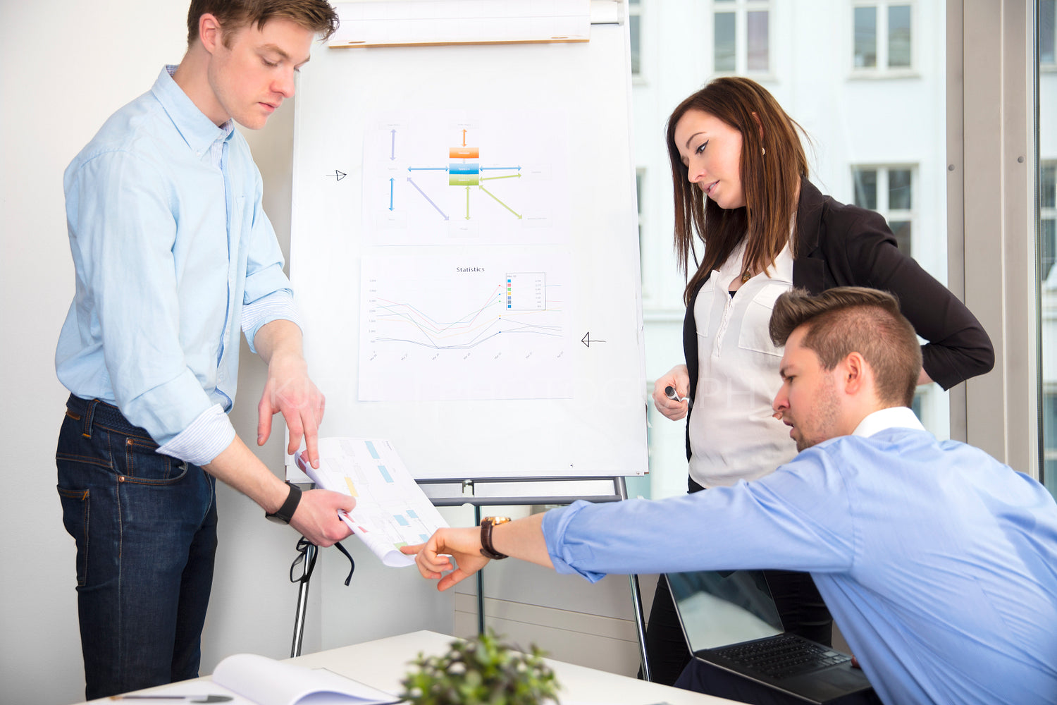 Business People Discussing Over Document In Office