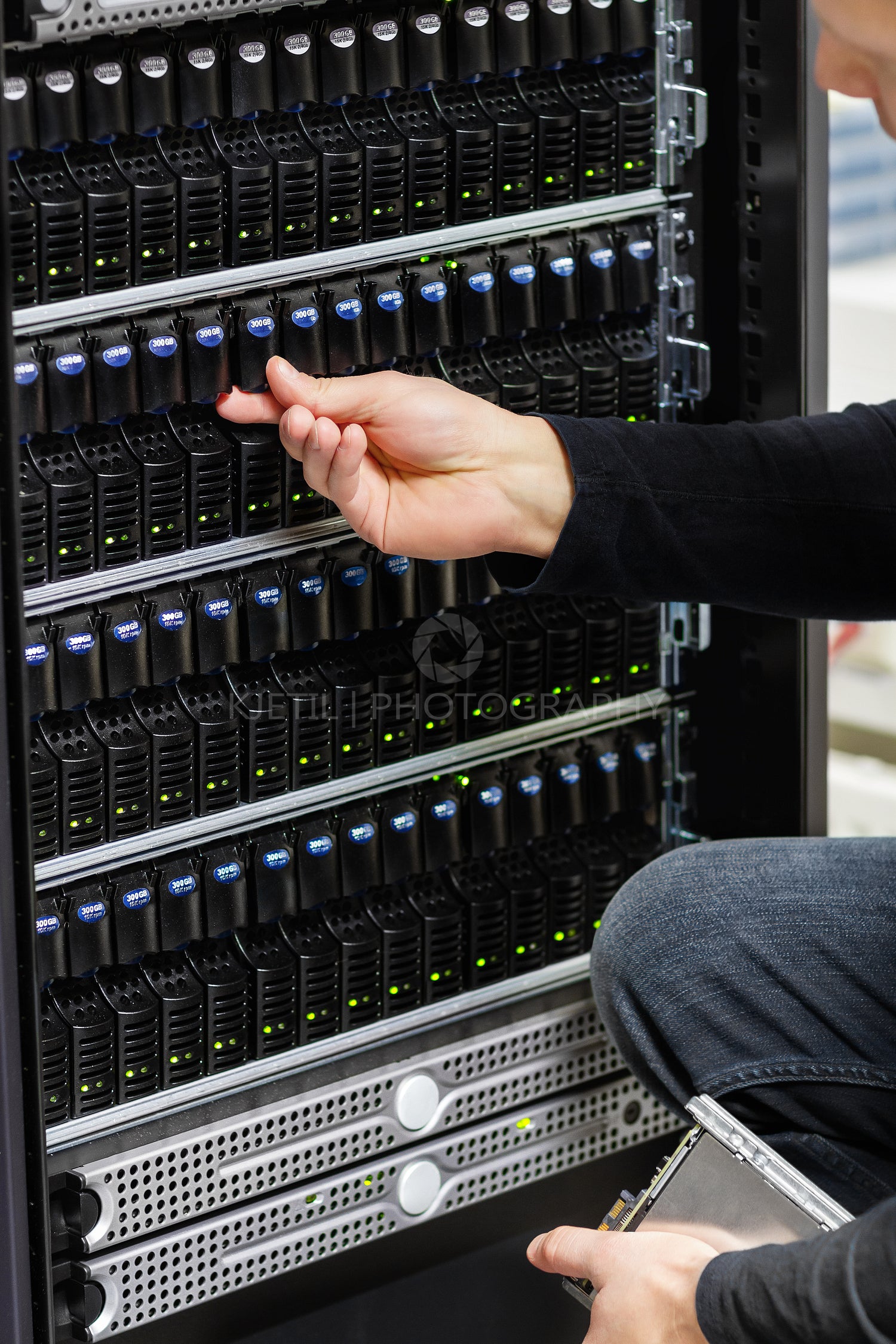 Male Technical Consultant Checking SAN array in Datacenter