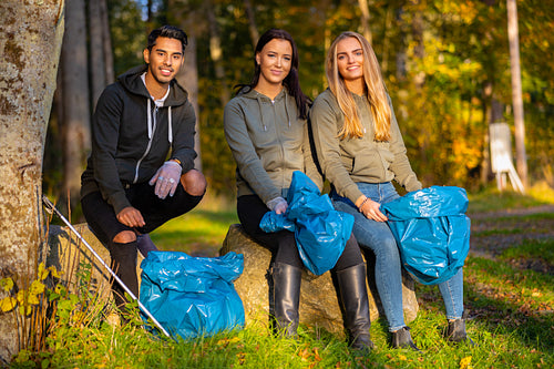 Motivated team of young volunteers picking up garbage