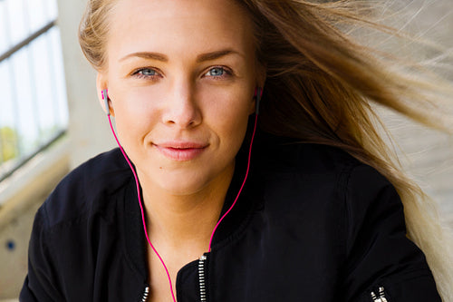 Close Portrait of Blonde Woman In Sportswear Listening To Music