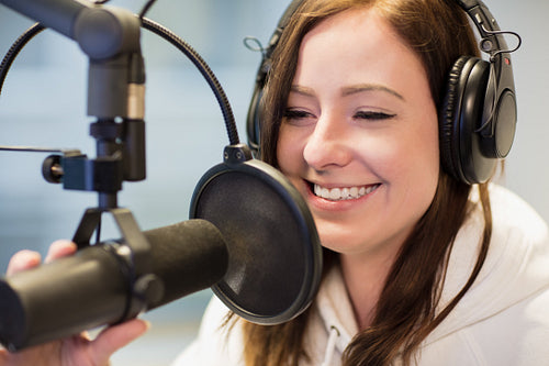 Jockey Smiling While Using Headphones And Microphone In Radio St