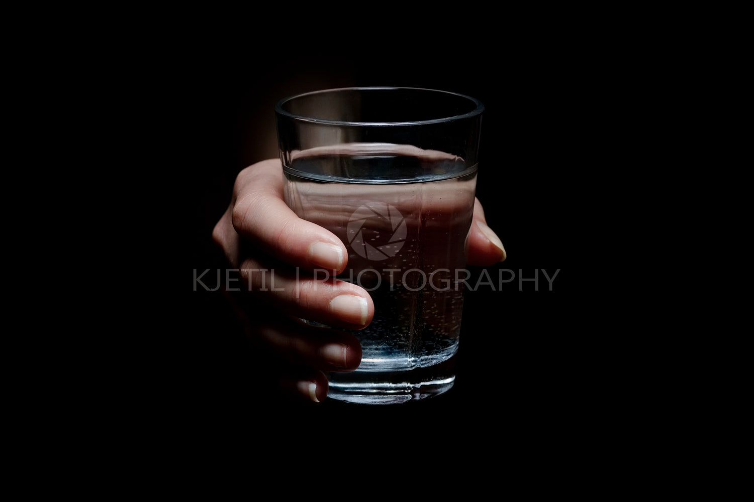 Woman Holding a Glass of Water