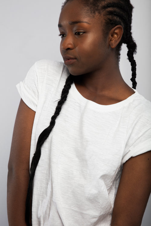 Woman With Braided Hair Looking Away Over Gray Background