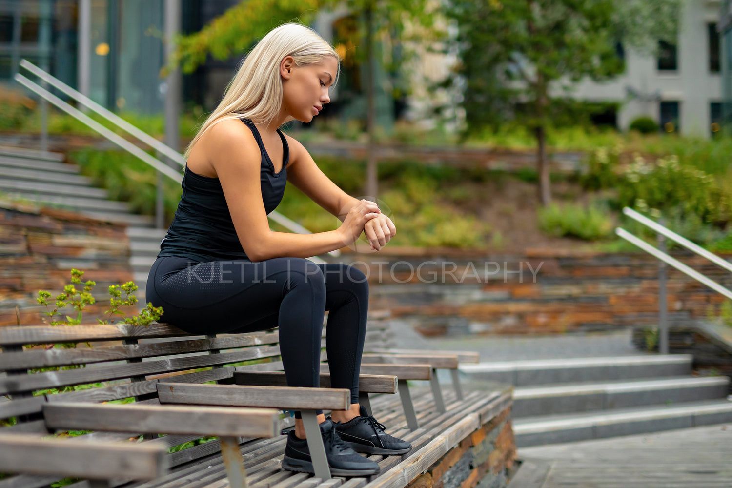 Fit woman setting up fitness smart watch device before running