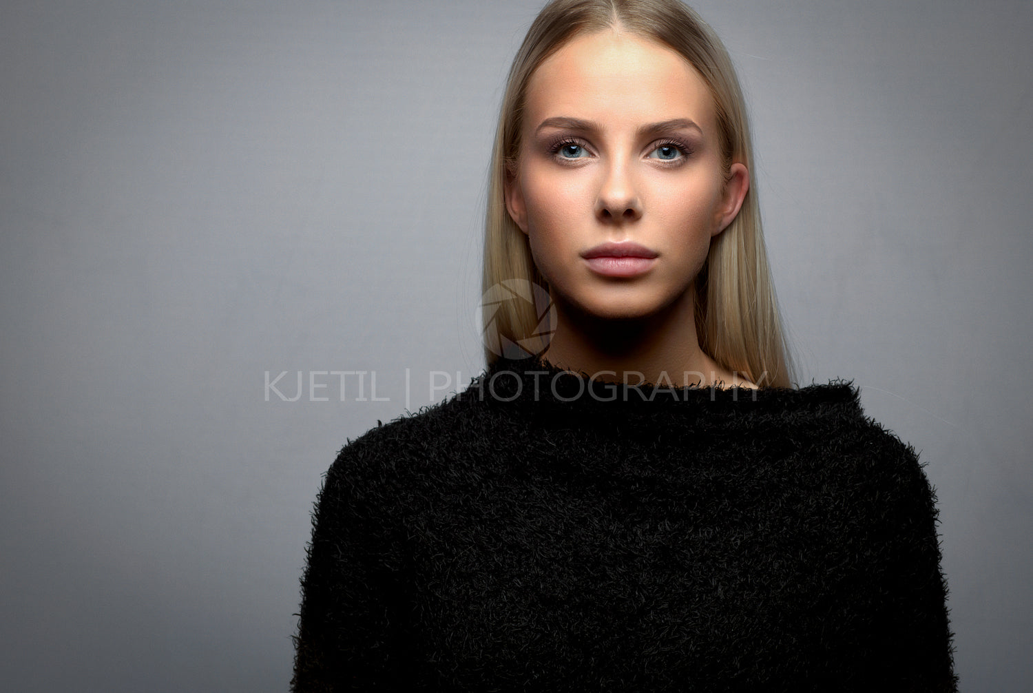 Studio portrait of a young blonde woman with fury jacket