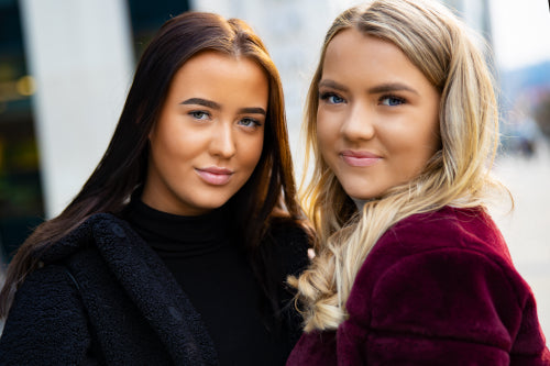 Close-up Portrait Of Smiling Beautiful Young Women Friends In City