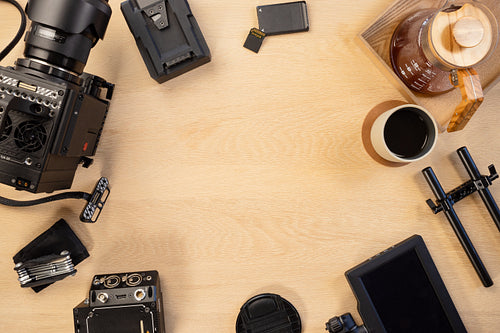 Directly above shot of filming equipment and coffee arranged on table