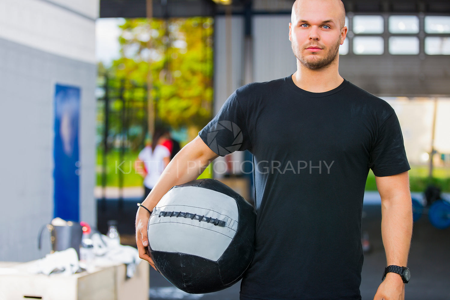 Confident Male Athlete Holding Medicine Ball In Health Club