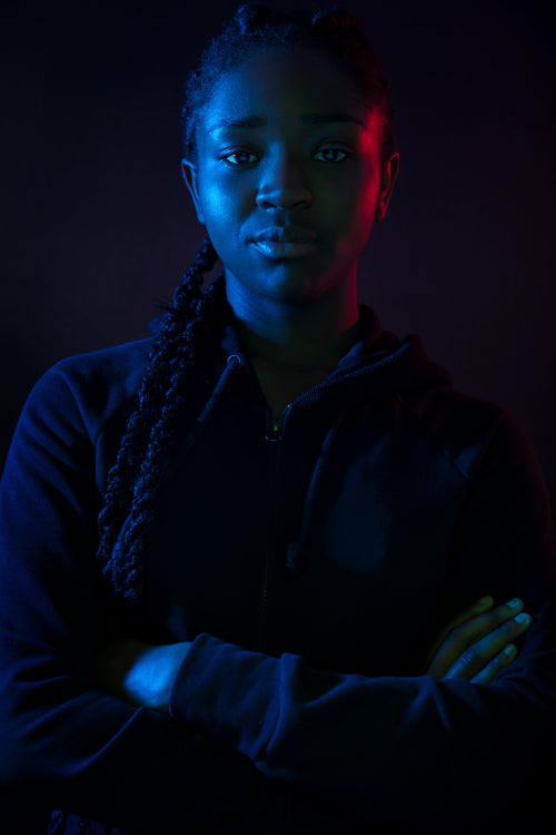 Dark colorful portrait of confident african woman with dark skin