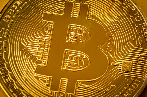 Top view closeup photo of one gold bitcoin