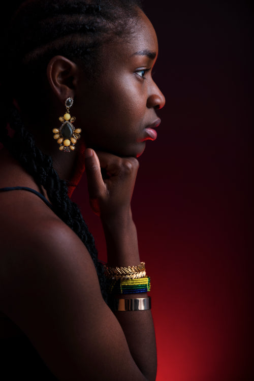 Colorful and creative side view portrait of african woman with dark skin