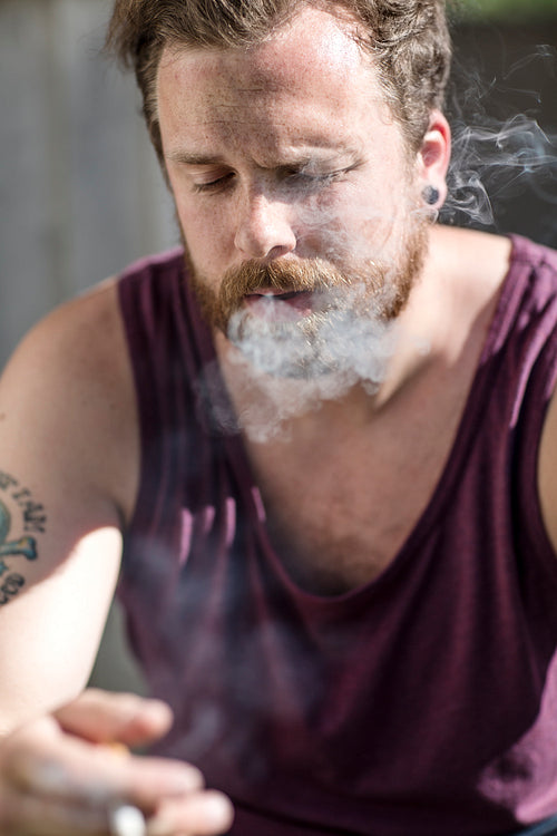 Close up of man who smokes on the staircase