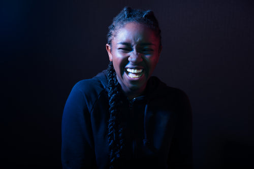 Woman Laughing Over Black Background