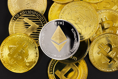 Close-up of Ethereum on top of various golden cryptocurrencies