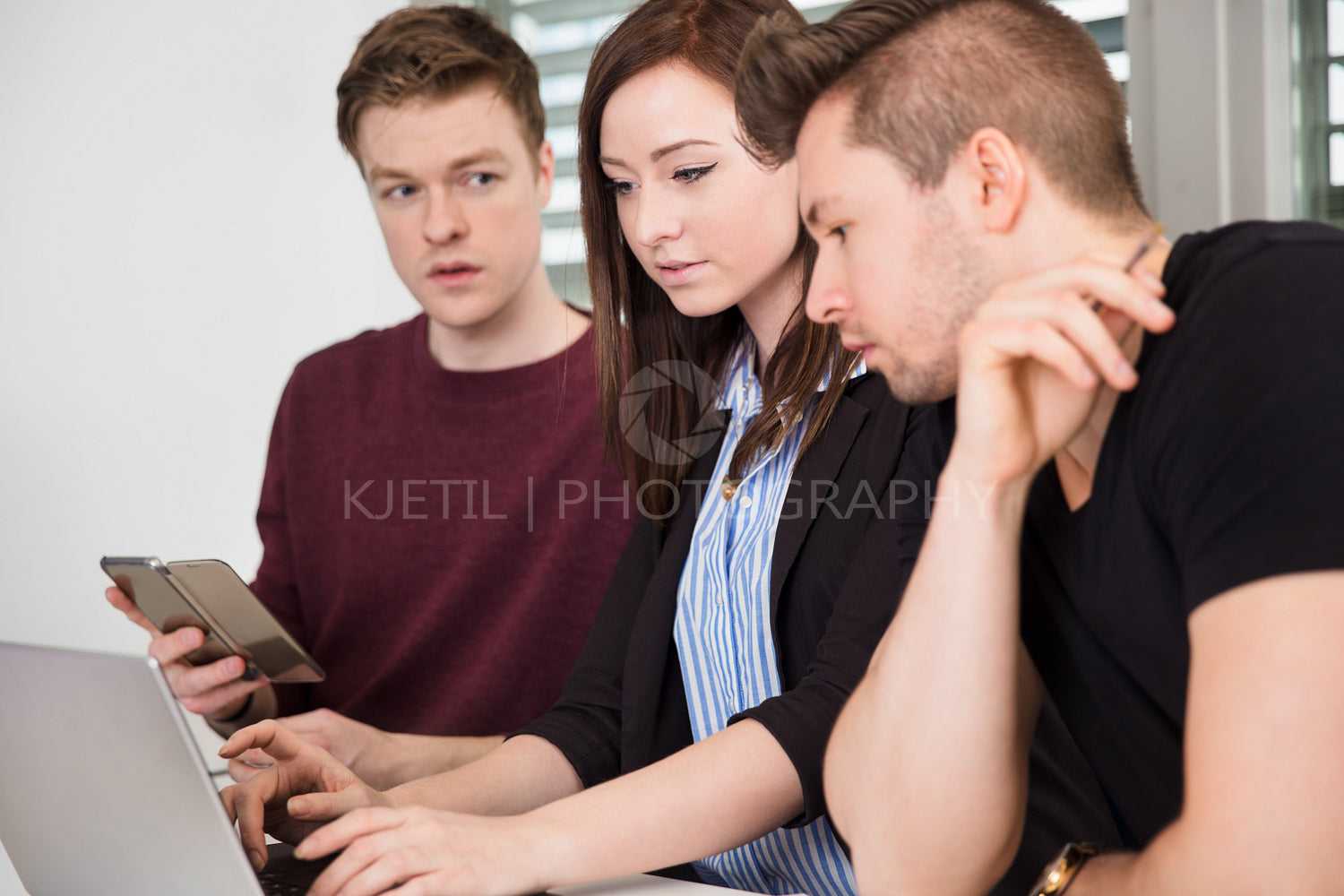 Businesswoman Using Laptop By Colleagues