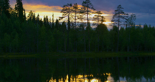 Beautiful sunset over a lake in the finnish forest