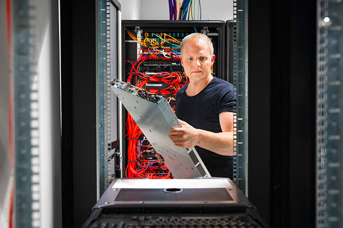 IT Engineer Arranging Server At Datacenter