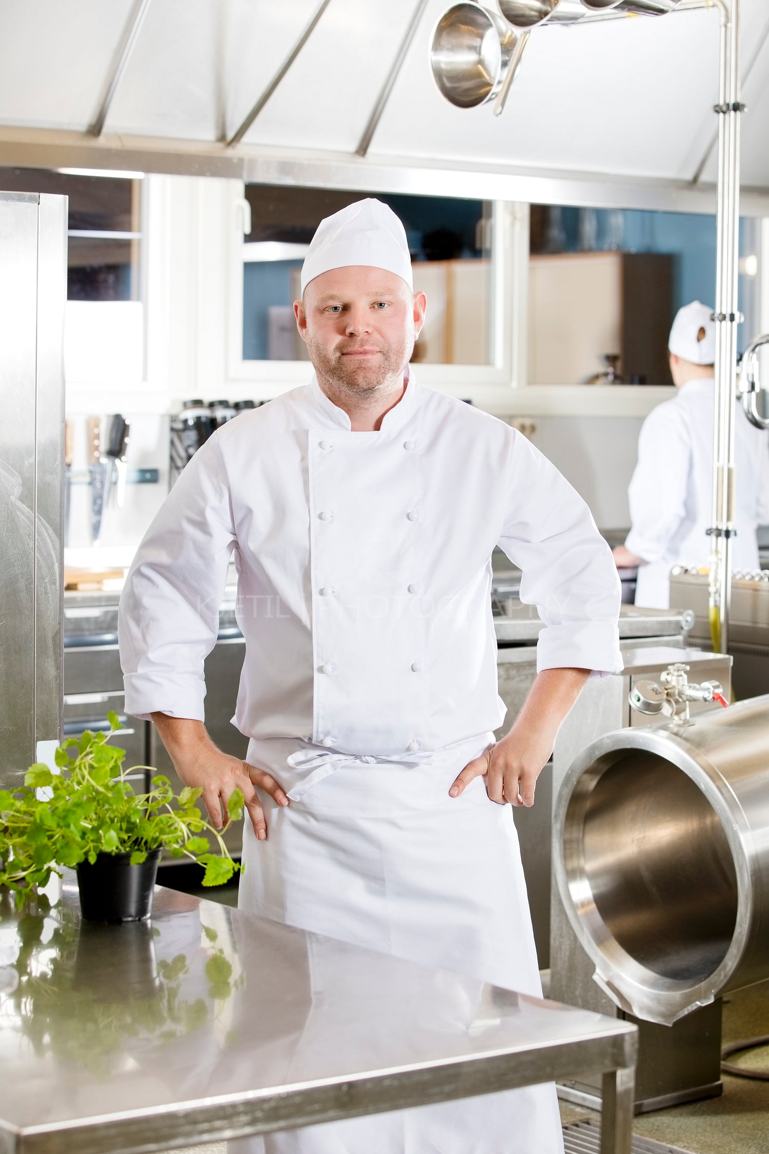 Professional chef standing in large kitchen