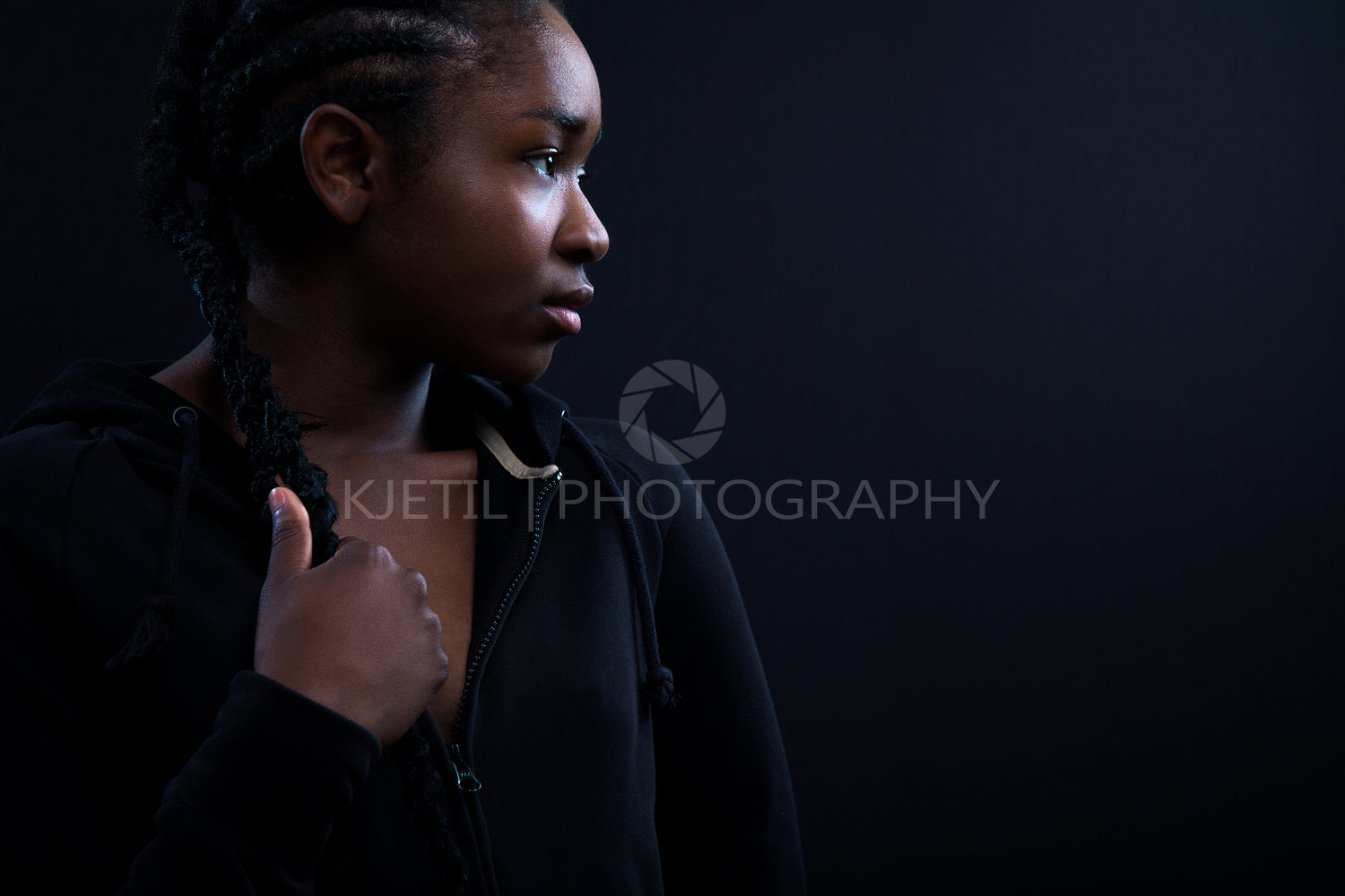 Model Looking Away Against Black Background