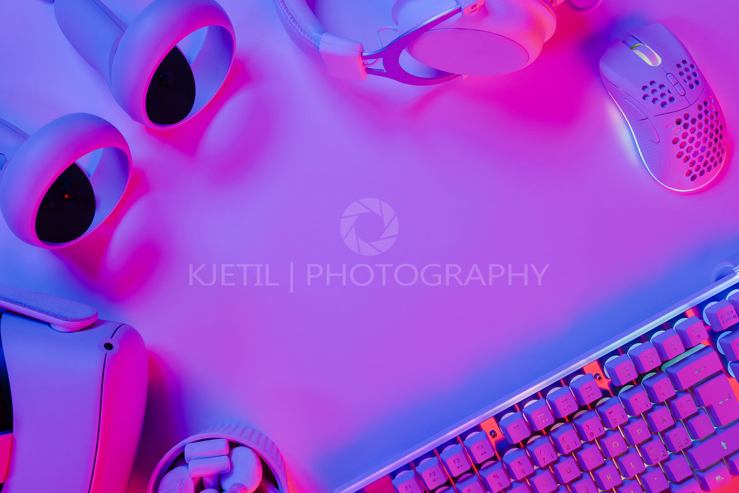 Illuminated keyboard and gaming gadgets on desk
