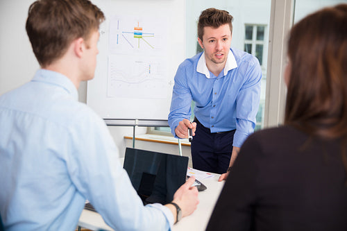 Businessman Discussing With Colleagues In Office