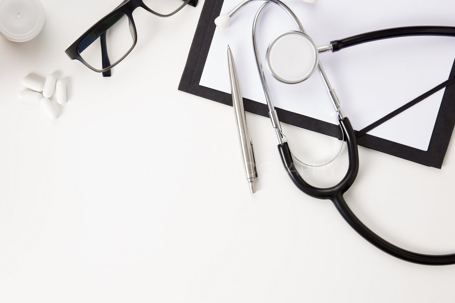 Doctors Office Desk with Thermometer And Medical Instruments On White