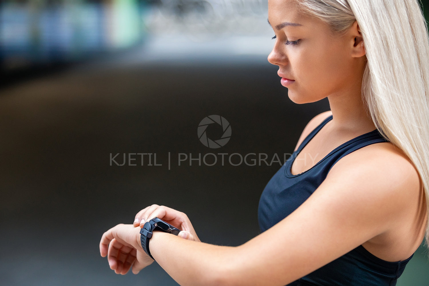 Female Runner Checking Smartwatch After Workout On Road