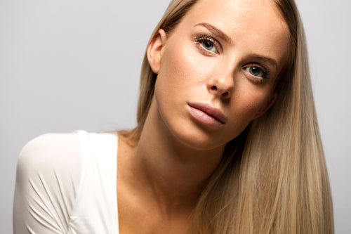 Portrait of a casual blonde woman in white top