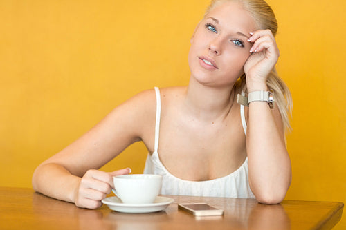 Smiling young woman drink coffee at cafe